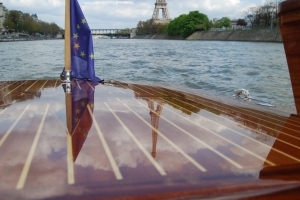 View of the Effeil tower from a wodden boat on the Seine river